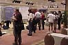 Attendees carry their plates while 
viewing the posters.